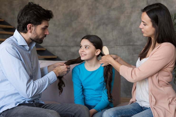 parents-brushing-daughter-hair_23-2148542839